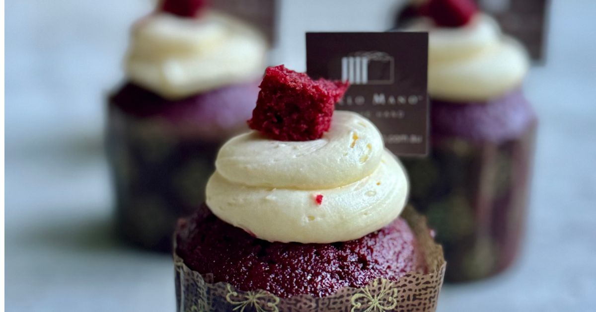 Red velvet cupcake with cream cheese frosting and Dello Mano chocolate topper, available at the Dello Mano West End cake shop.