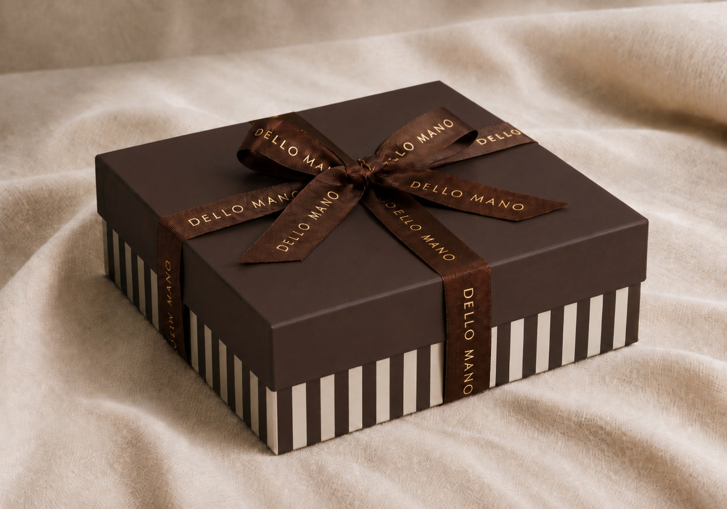 Premium Dello Mano chocolate gift box with gold-embossed grosgrain ribbon and striped base, handmade in Brisbane.