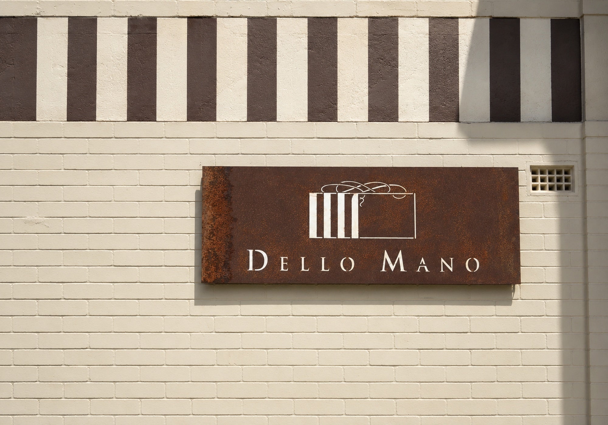 Dello Mano sign on the exterior of the West End kitchen in Brisbane, the neighbourhood that inspired our Greek-style Kourabiedes.
