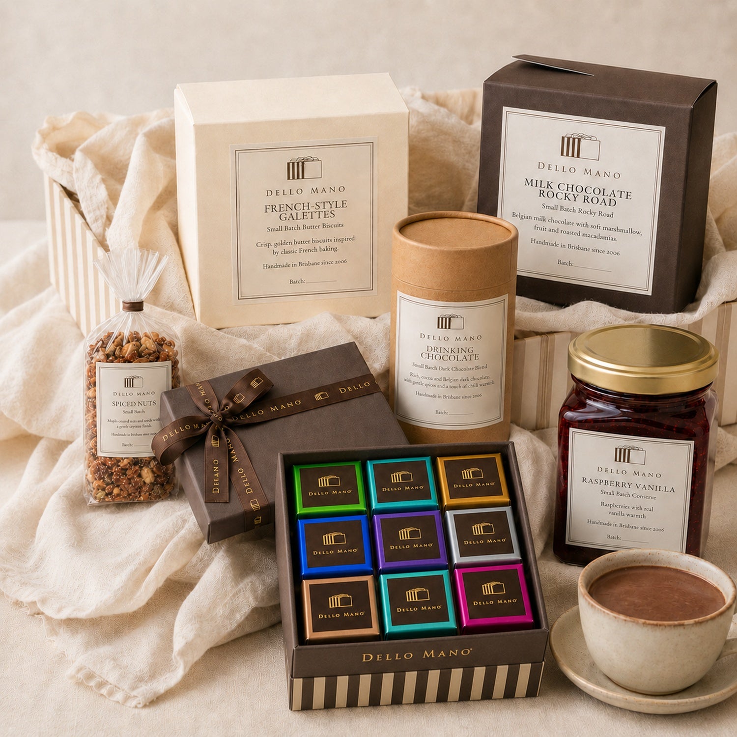 The Dello Mano Signature Hamper with a 9-piece mixed brownie gift box, French-style galettes, drinking chocolate, Rocky Road, spiced nuts and Raspberry Vanilla Jam.