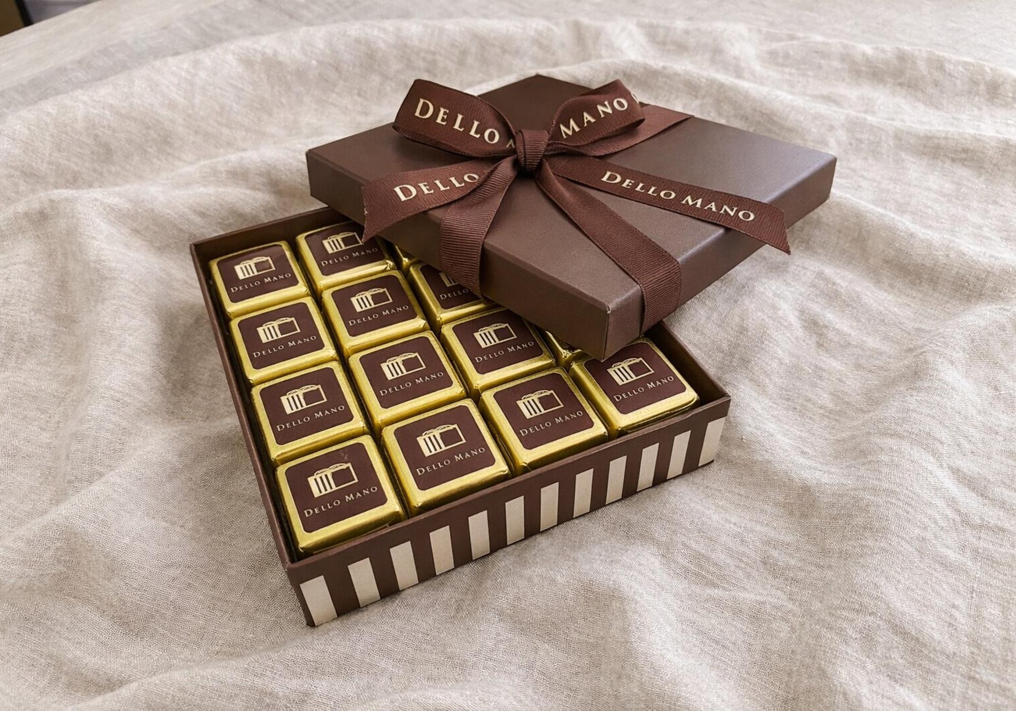 Luxury brownie gift box with individually wrapped brownies in gold foil, presented for gifting