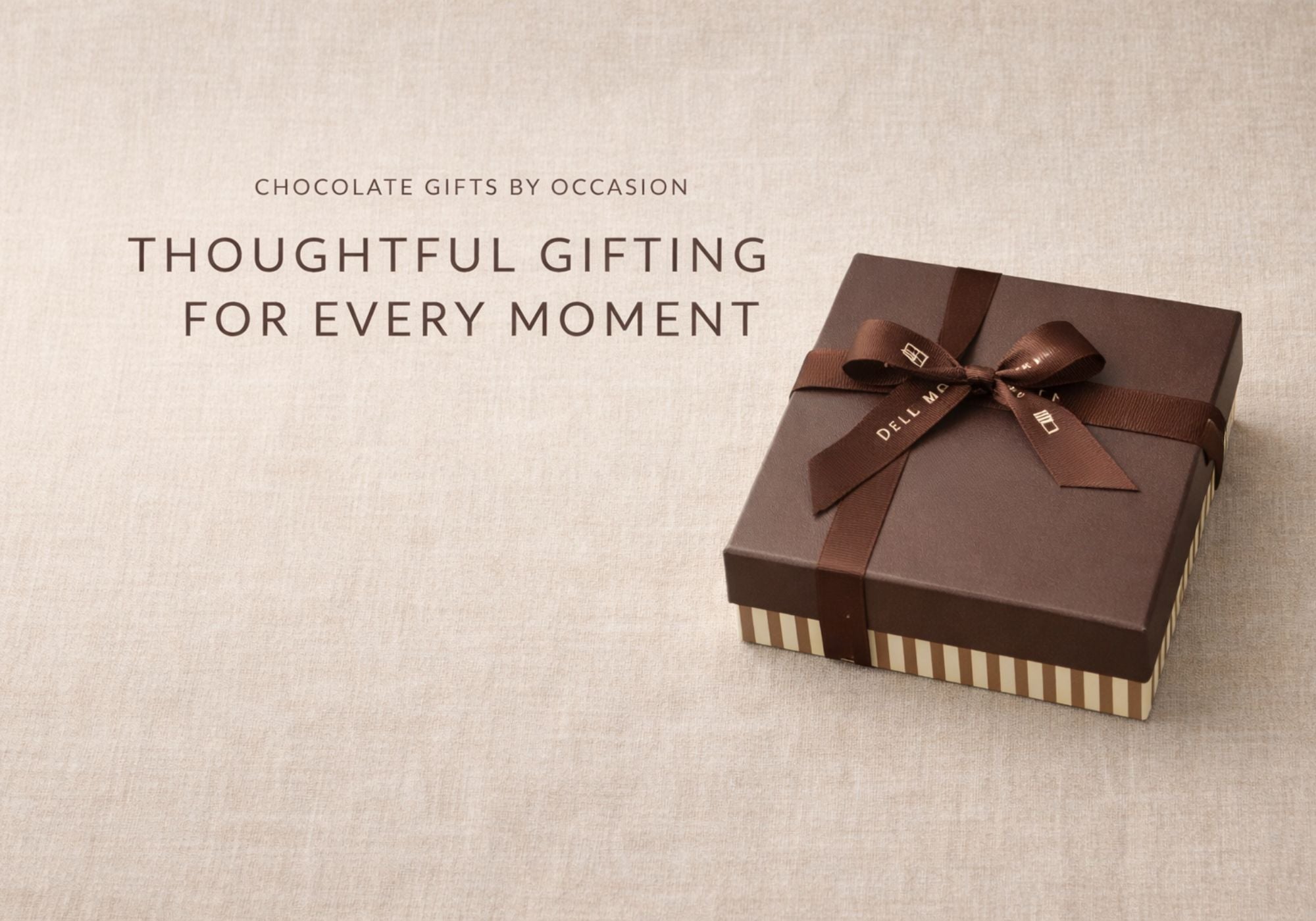 Dello Mano chocolate gift box with striped base and brown grosgrain ribbon on neutral linen background – premium chocolate gifts Australia