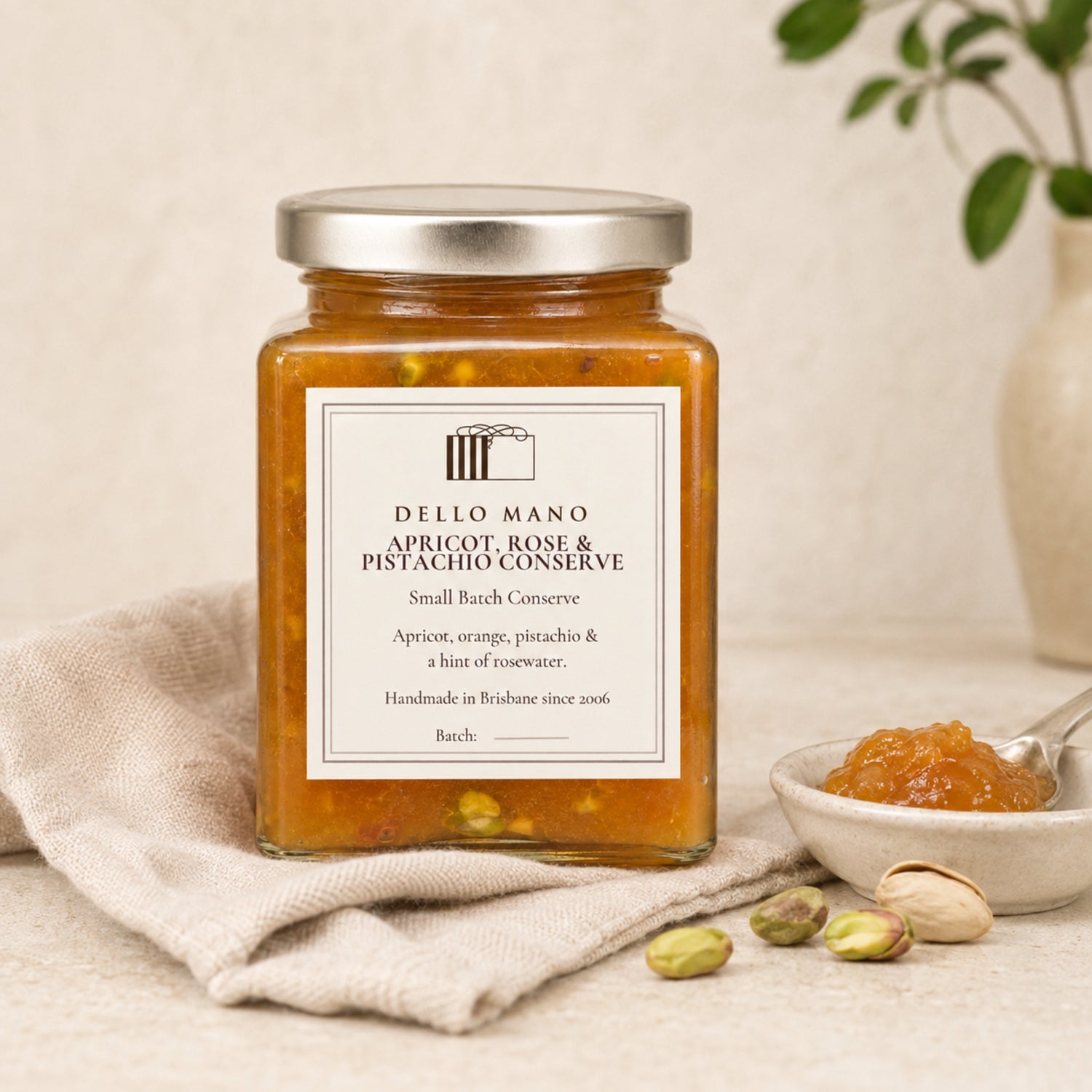 Dello Mano Apricot, Rose and Pistachio Conserve styled with pistachios on natural linen