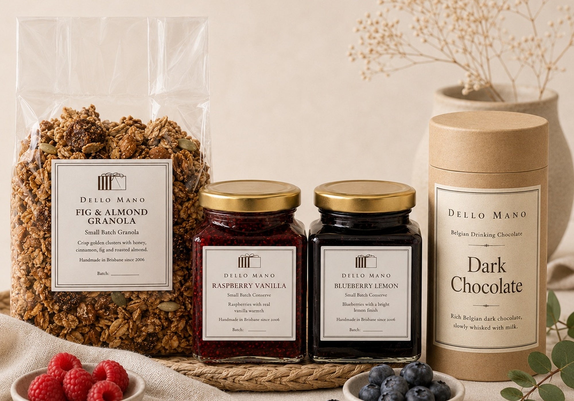 Dello Mano luxury breakfast hamper with granola, fruit conserves and dark drinking chocolate in calm gift styling.