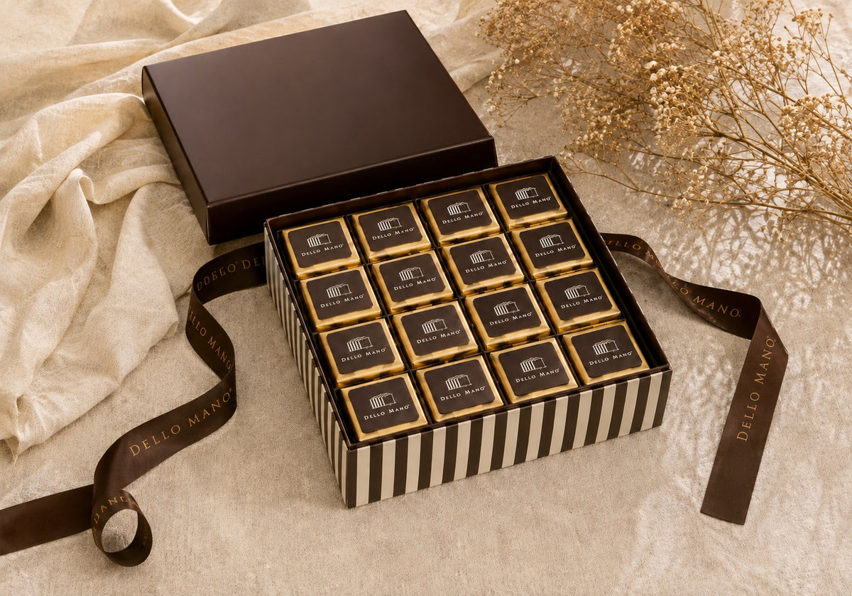 Open Dello Mano thank you brownie gift box with individually wrapped brownies, signature striped box and brown ribbon.
