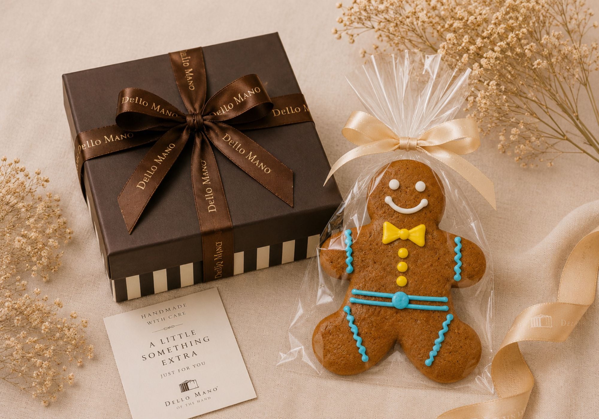 Handmade Gingerbread Boy Cookie gift add-on wrapped in a clear cello bag with ribbon, styled beside a Dello Mano brownie gift box on natural linen. Ideal for brownie gifts, hampers and family treats.