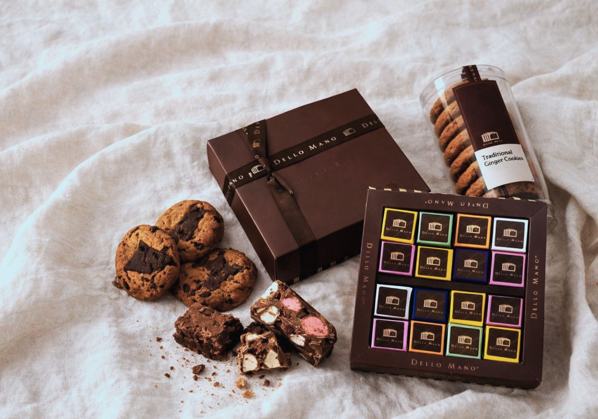 Handmade chocolate hamper contents with brownies cookies and artisan treats on soft linen background in Australia