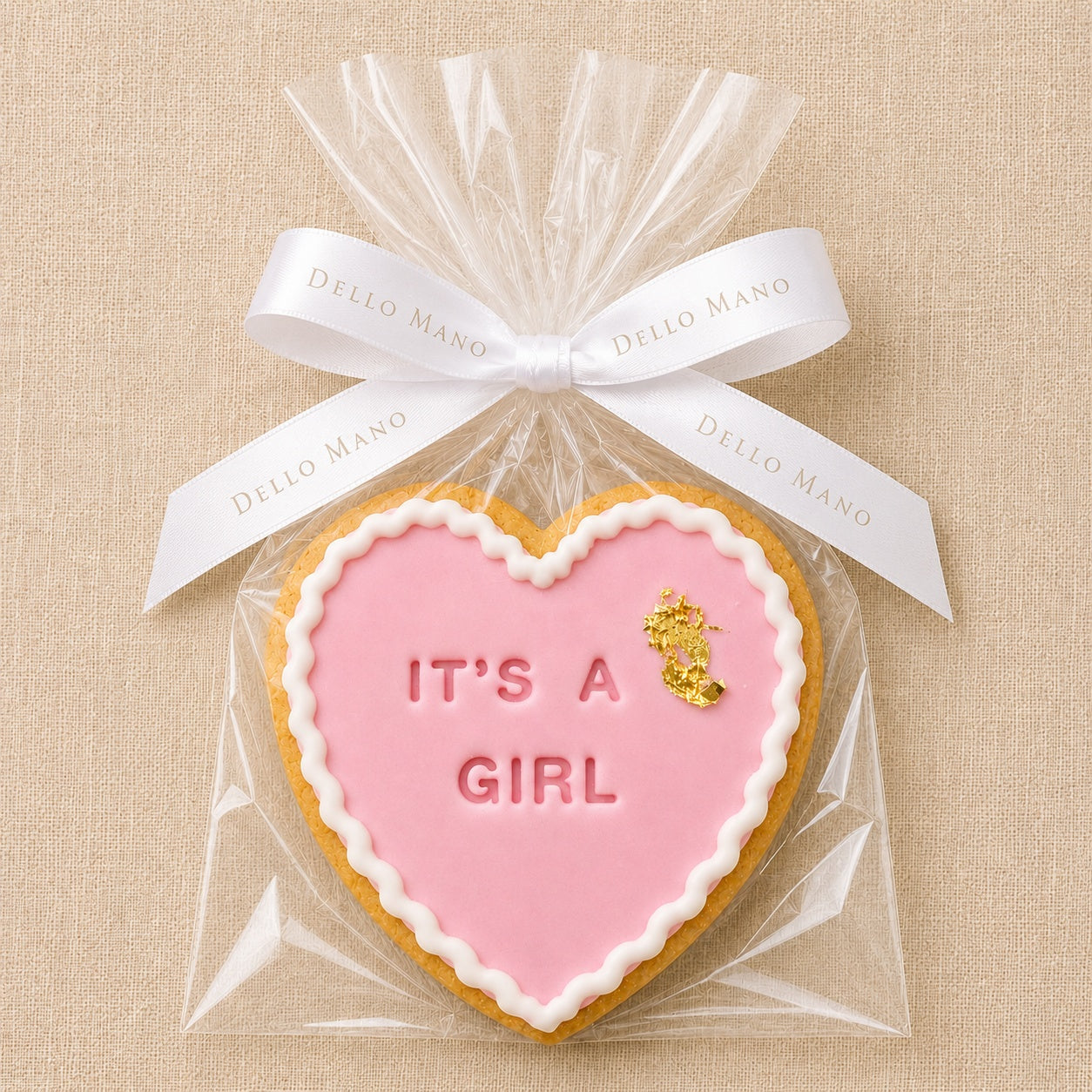 Wrapped handmade It’s A Girl cookie for baby shower favours, new baby girl gifts and gender reveal celebrations.