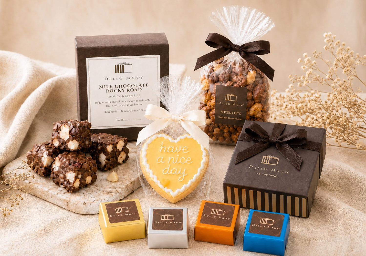 Luxury gift hamper contents by Dello Mano with rocky road, spiced nuts, iced cookie and chocolate treats.