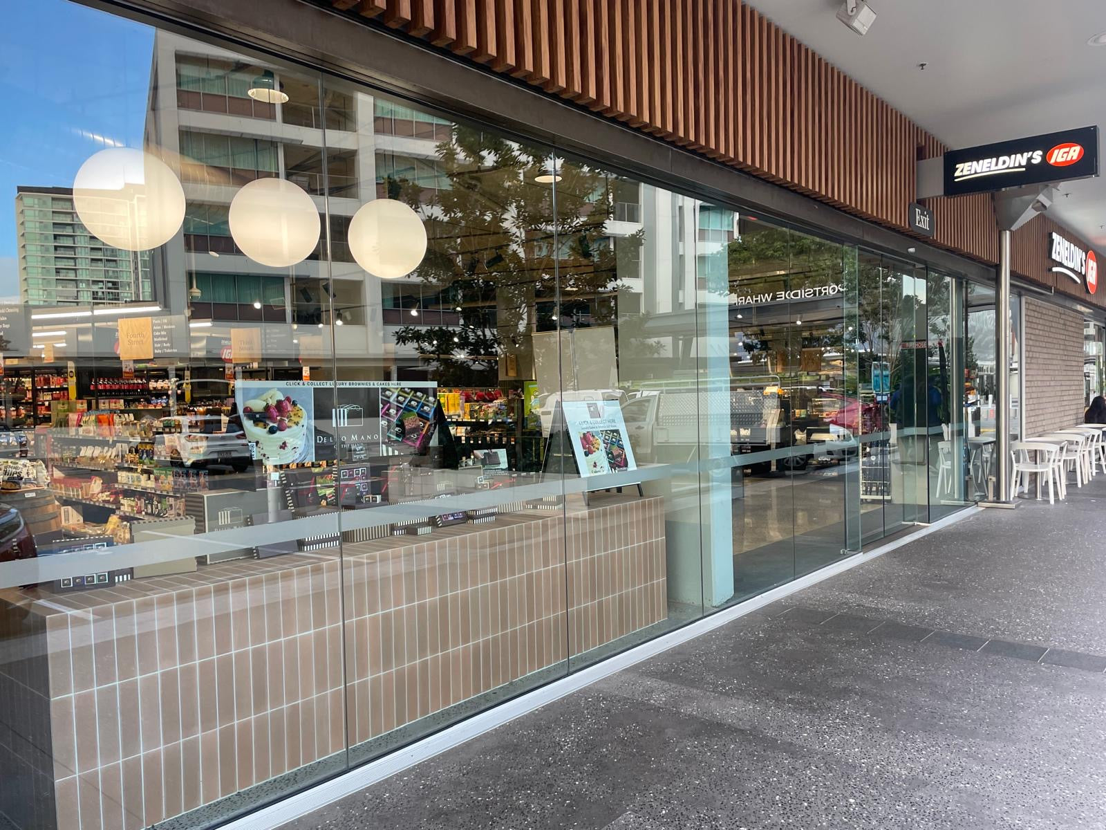 Zeneldins IGA Hamilton store frontage with Dello Mano handmade brownies and cakes promoted in the window
