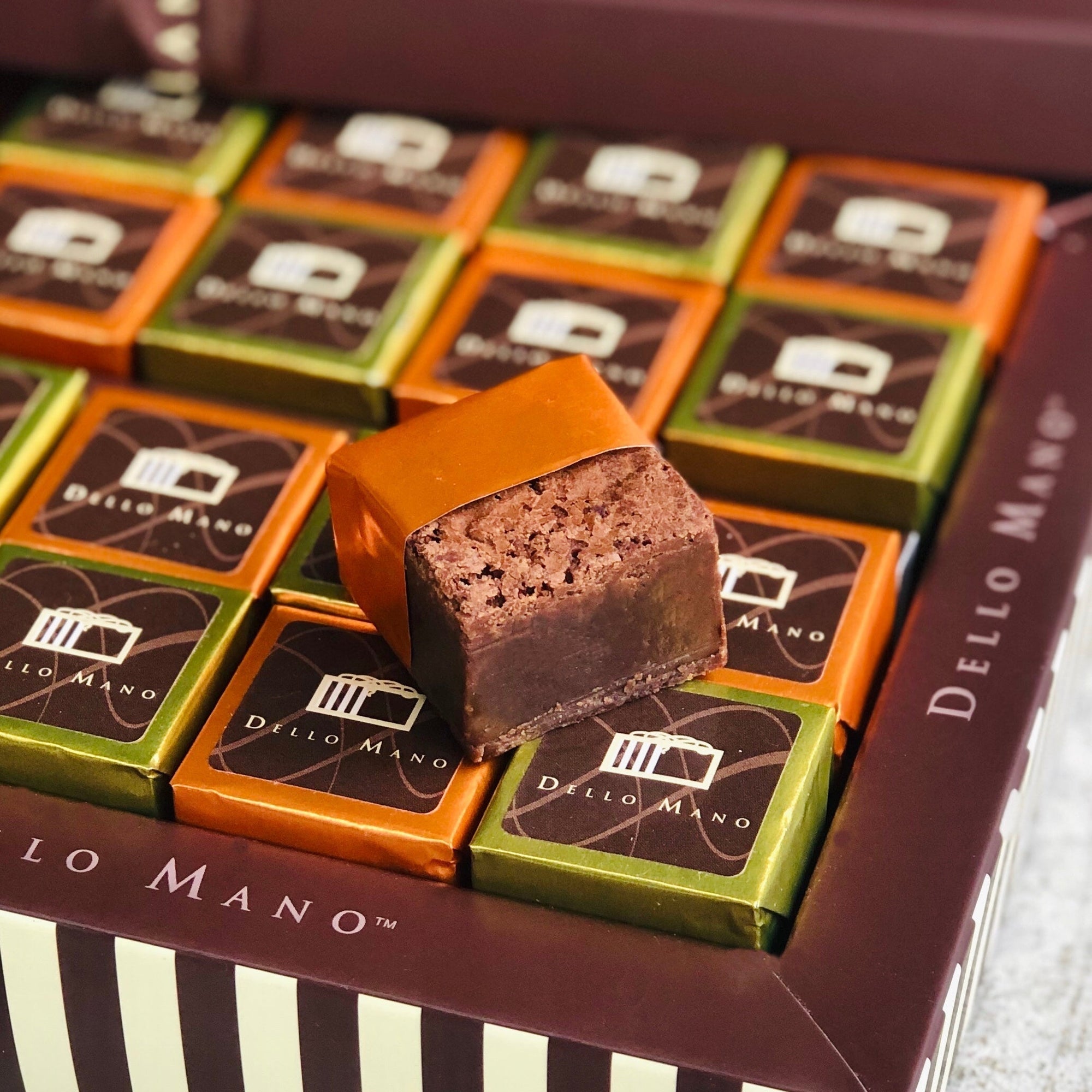 Dello Mano luxury brownie gift box showcasing individually wrapped Belgian chocolate brownies in classic and salted caramel flavours