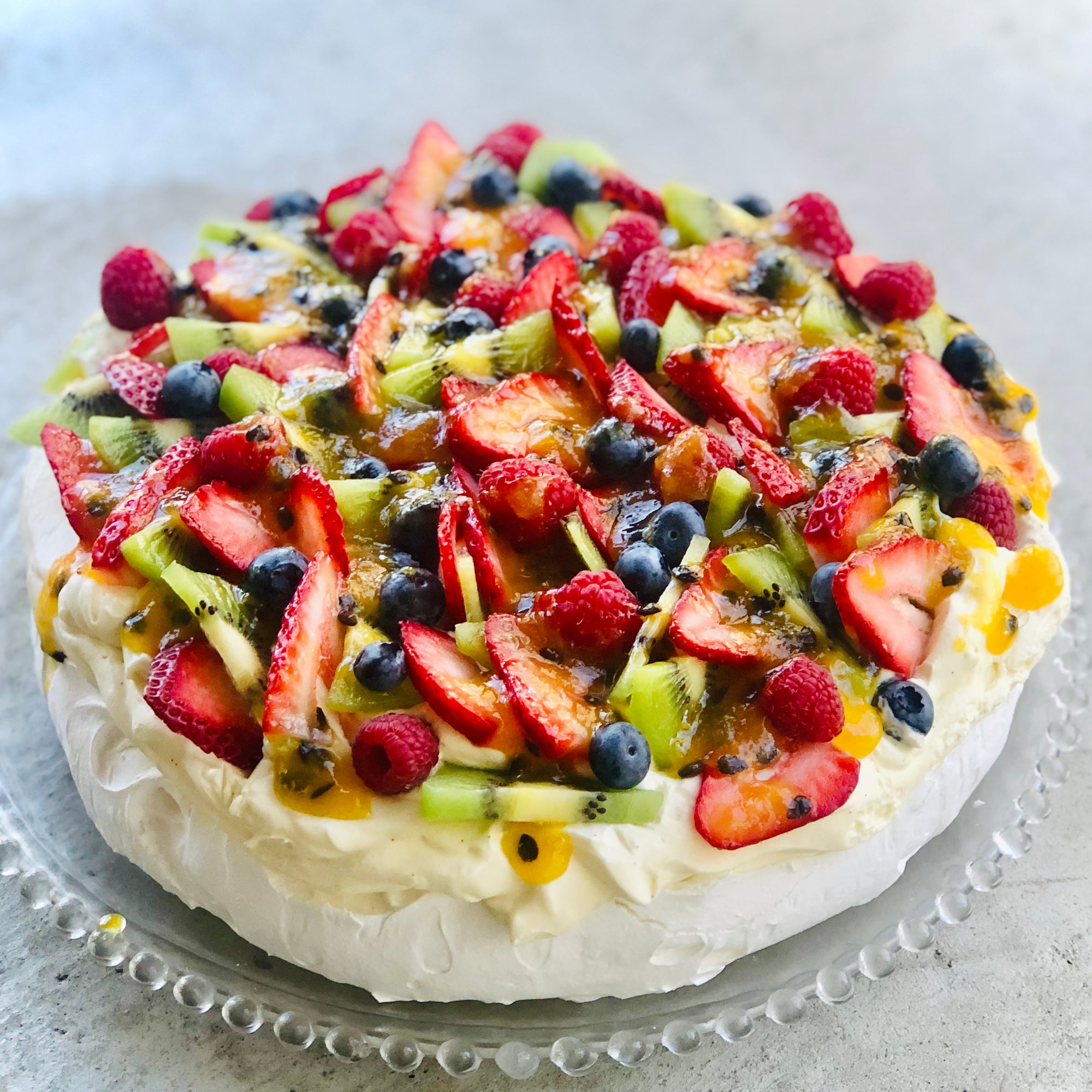 A Dello Mano Pavlova with strawberries, kiwifruit, blueberries and passionfruit