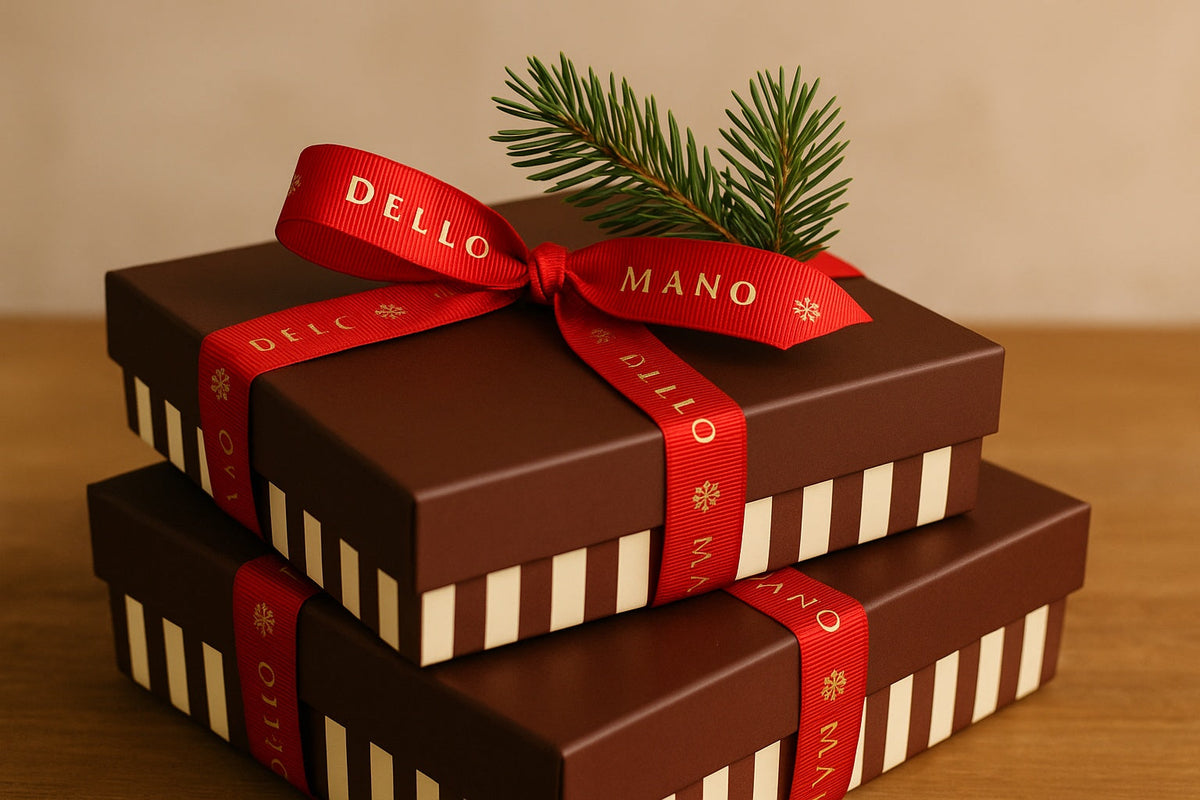 Dello Mano handmade luxury Christmas gifts – two chocolate brown striped gift boxes tied with red grosgrain ribbon and a pine sprig, crafted in Brisbane, Australia.