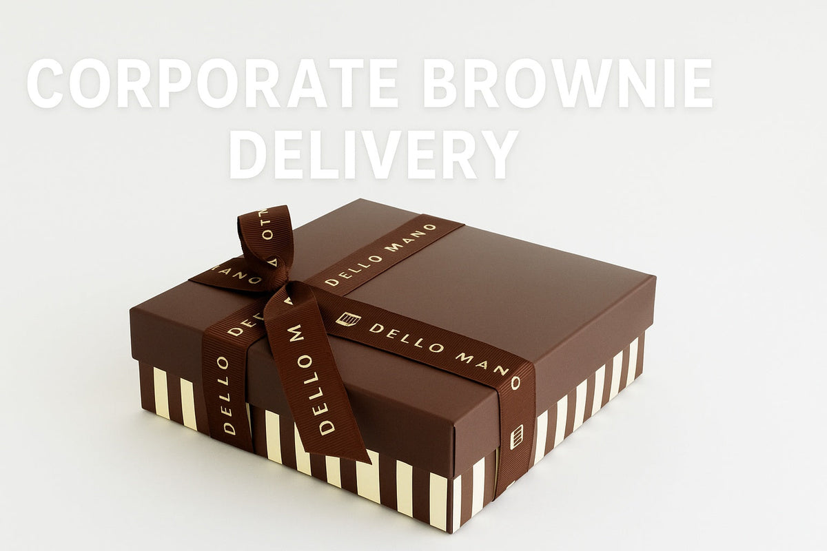“Dello Mano corporate brownie gift box wrapped in brown ribbon with gold lettering, presented against a clean white background with text reading ‘Corporate Brownie Delivery