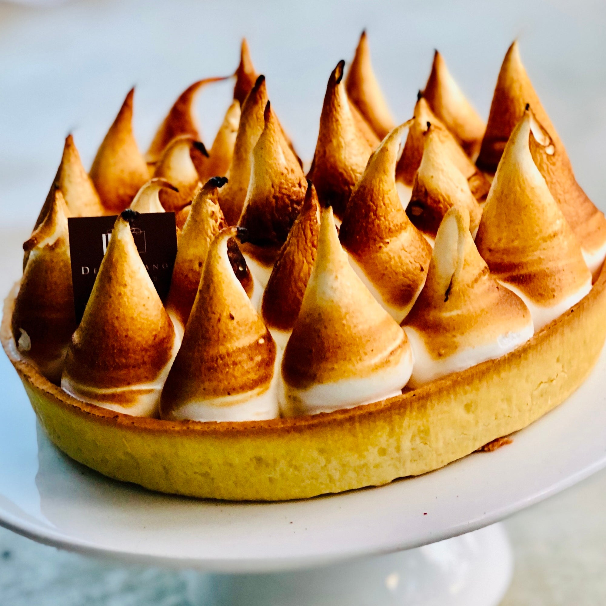 A Lemon Curd Tart with peaks of toasted meringues 