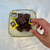 hand selecting luxury brownies from a Korean decorative plate