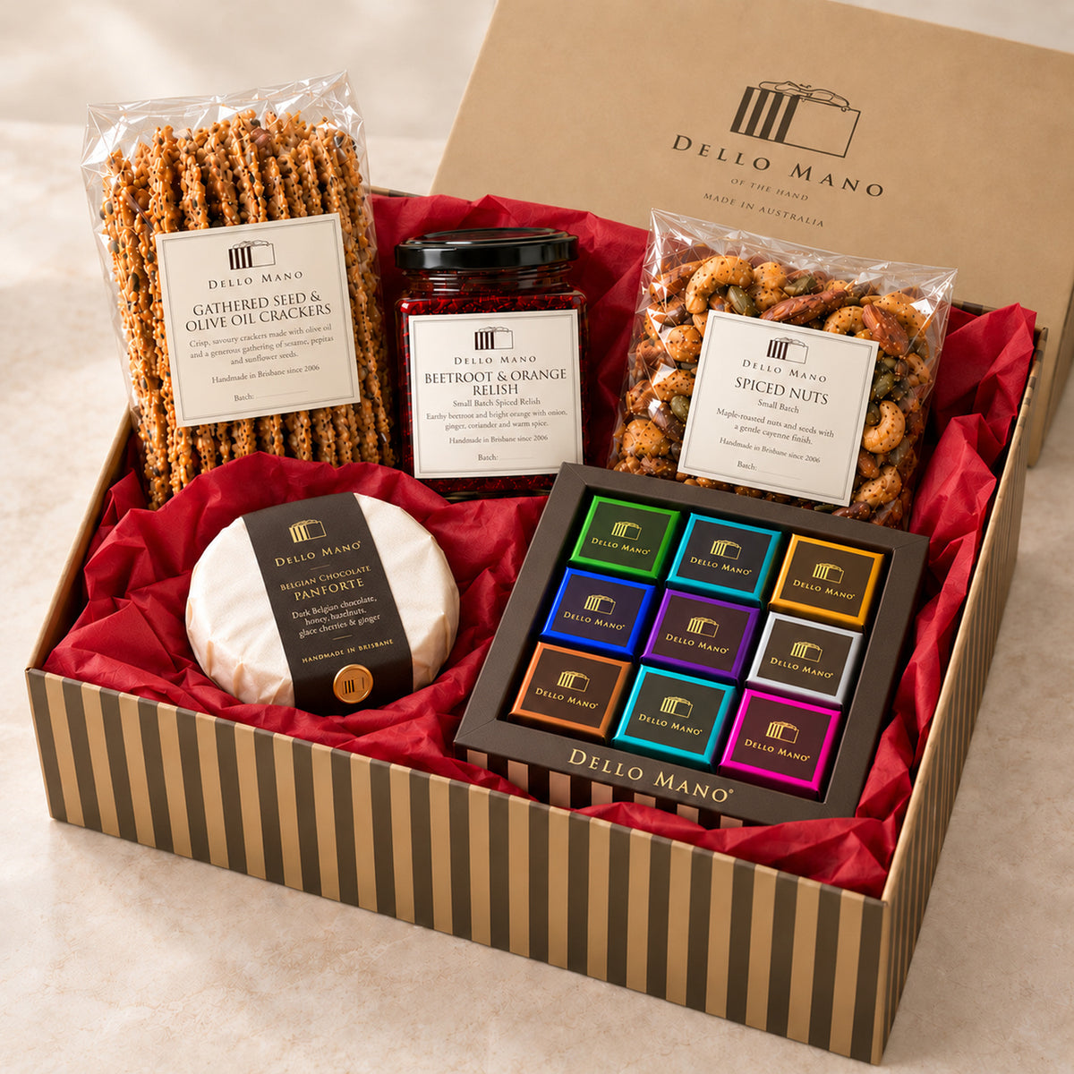 Open Dello Mano Christmas Celebration Hamper with nine mixed brownies, panforte, beetroot and orange relish, seed crackers and spiced nuts nestled in red tissue.