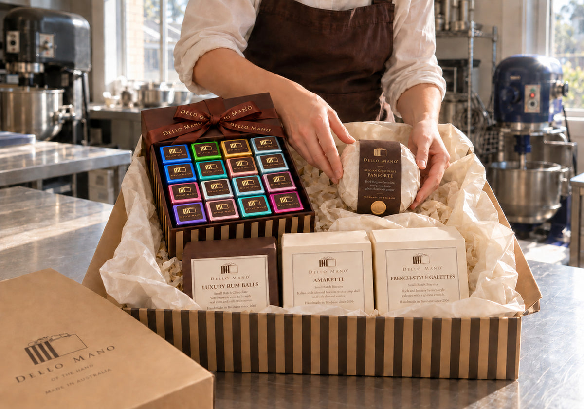 A Dello Mano team member packs the Christmas Indulgence Hamper with a 16-piece mixed brownie gift box, panforte, rum balls, amaretti and French galettes.