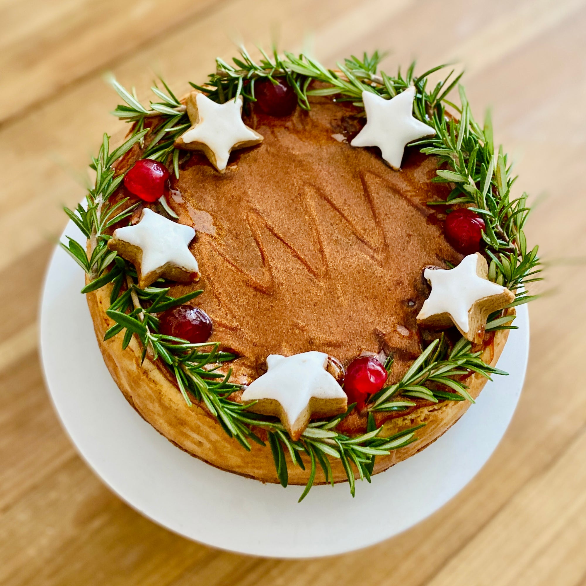 Glistening Gold Glaze, Rosemary Wreath, and Frosted Gingerbread Stars atop Starstruck Gingerbread Cheesecake