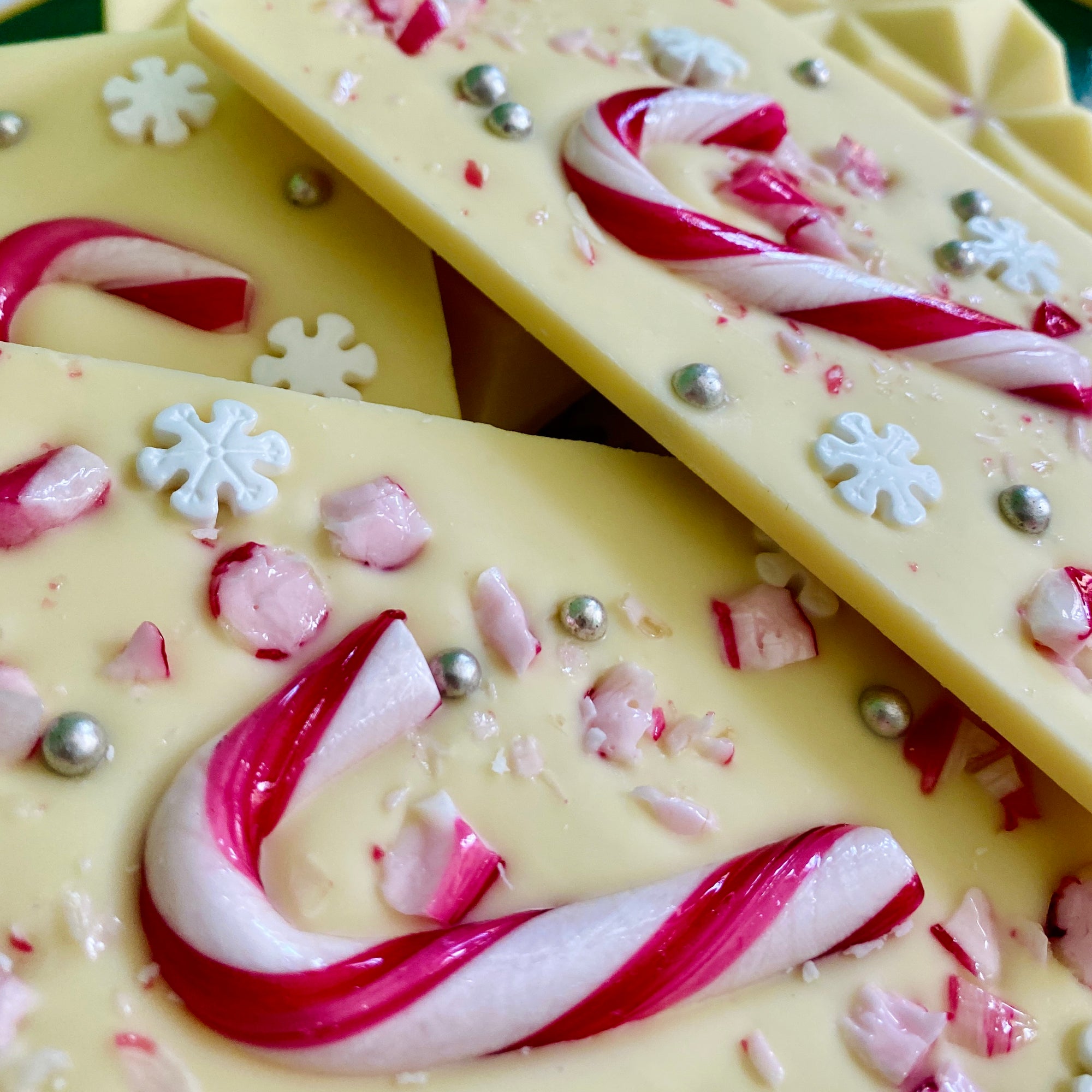 Snowy Peppermint Bliss - A single 110g white Belgian chocolate bar adorned with candy canes, silver sugar balls, and snowflakes