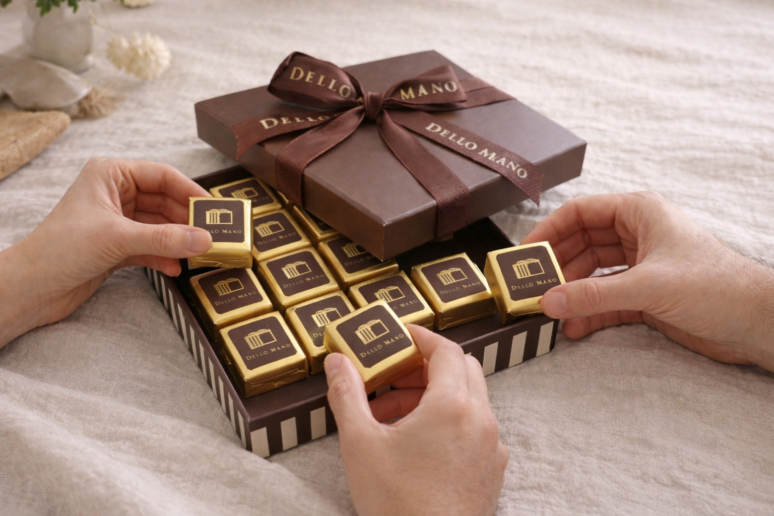 Birthday brownie gifts Australia – shared Dello Mano brownie box with hands reaching in to enjoy individually wrapped chocolate brownies