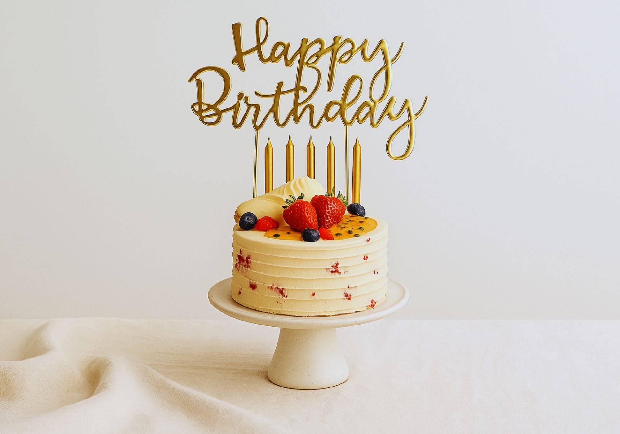 Elegant handmade birthday cake with candles and fruit topping for birthday cake celebrations in Brisbane CBD by Dello Mano