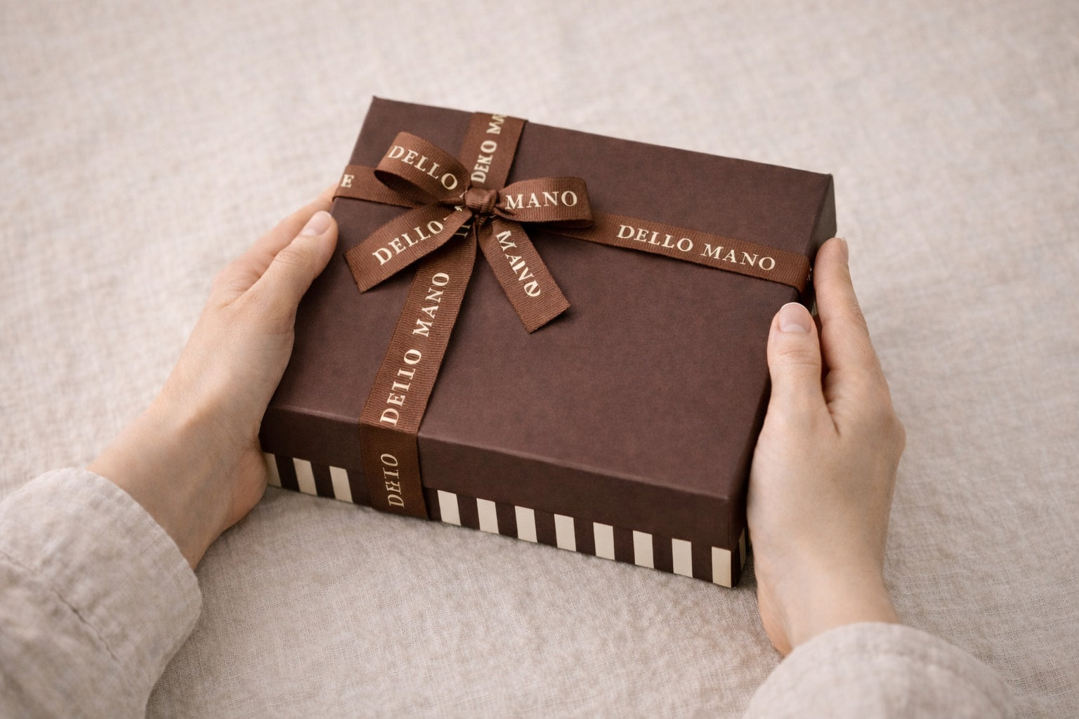 Handmade brownie gift box being held as a thoughtful gift in a calm linen setting