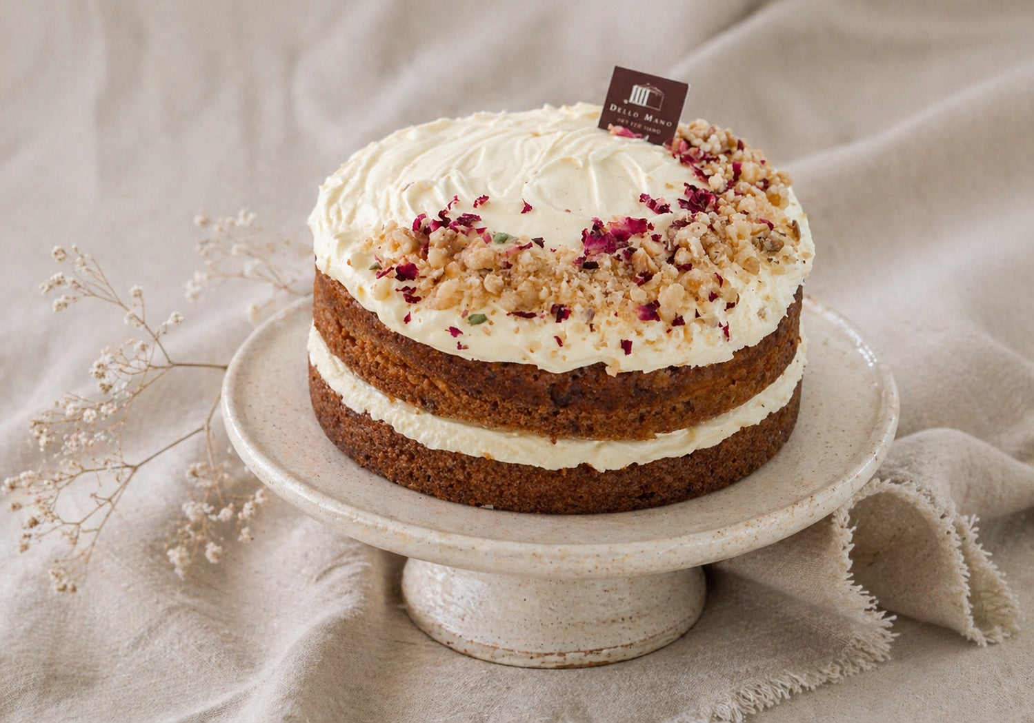 handmade carrot cake Brisbane on ceramic stand styled with soft linen background in natural light