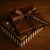 Box of chocolate brownies with 'Dello Mano' branding on a wooden surface.