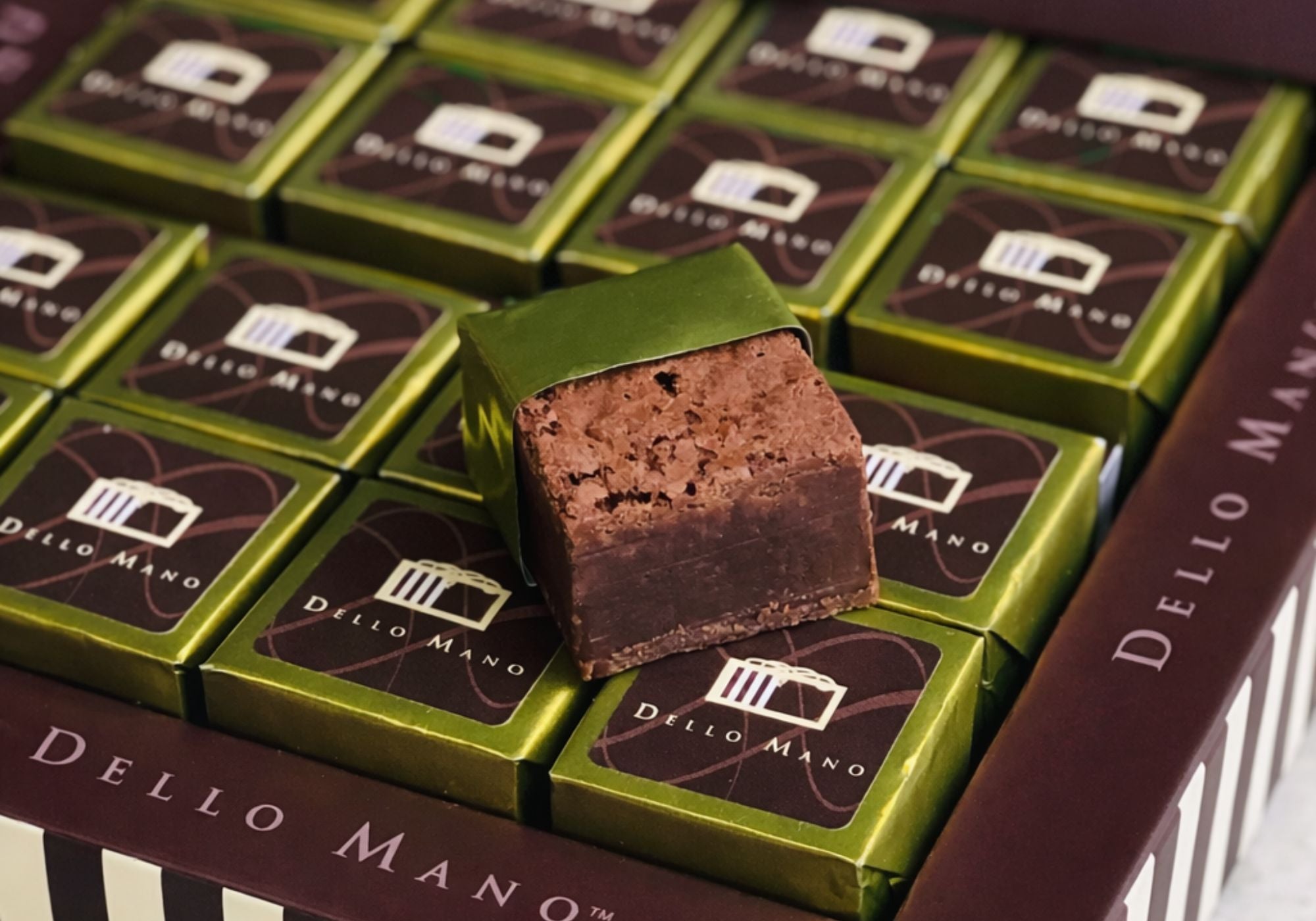 Chocolate gift box with gold foil wrapped brownies by Dello Mano