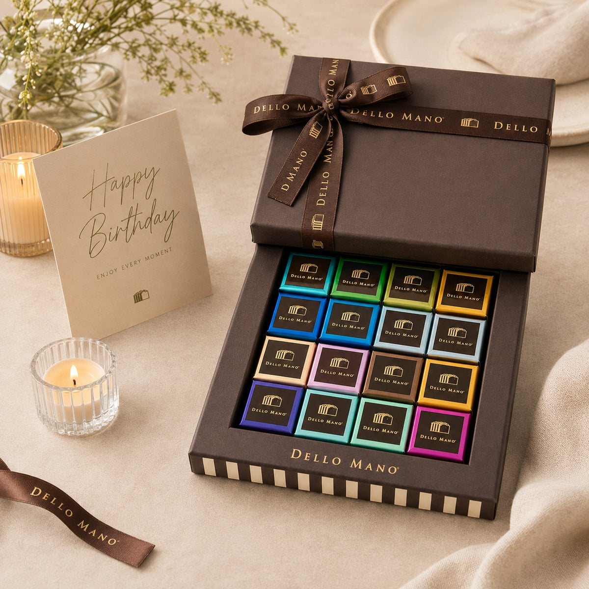 Dello Mano Signature Mixed Brownie Gift Box with colourful individually wrapped brownies, a birthday card and candles.