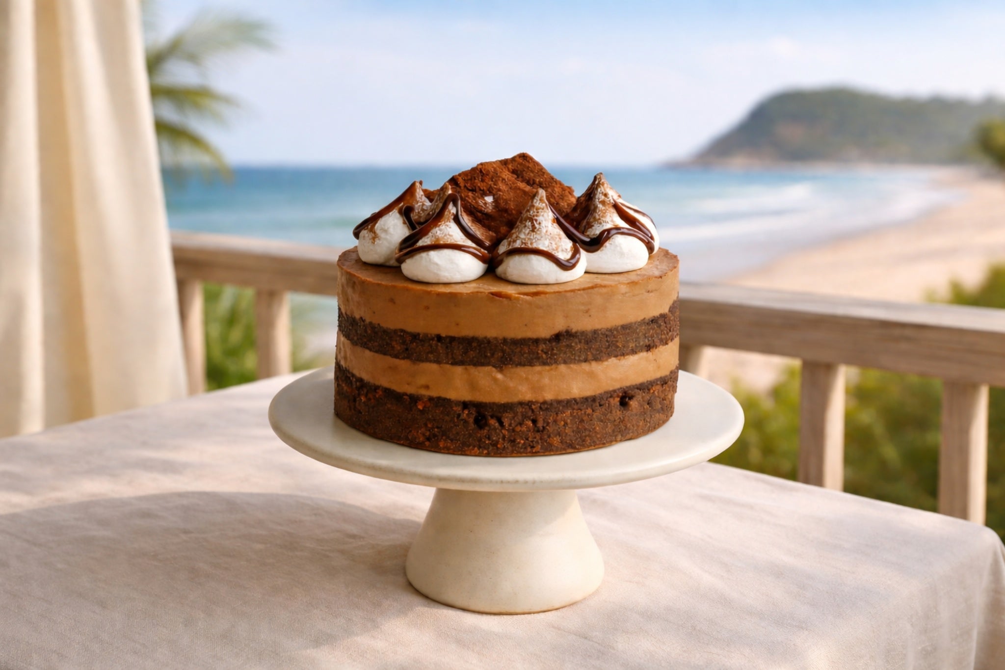 Handmade chocolate cake on balcony overlooking Gold Coast for cake delivery by Dello Mano