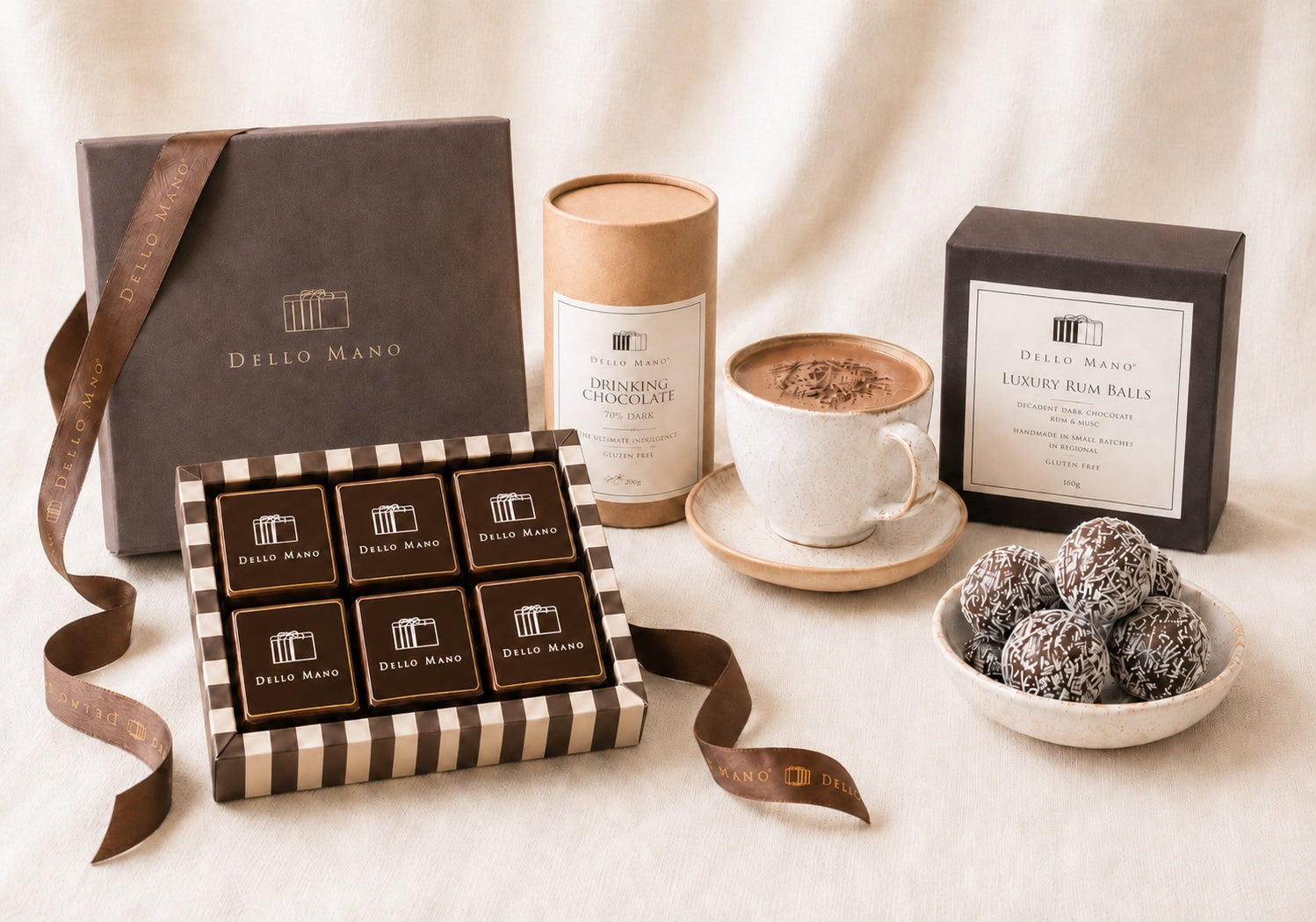Dello Mano chocolate hamper selection with wrapped brownies, dark drinking chocolate, Luxury Rum Balls and a prepared cup of hot chocolate.
