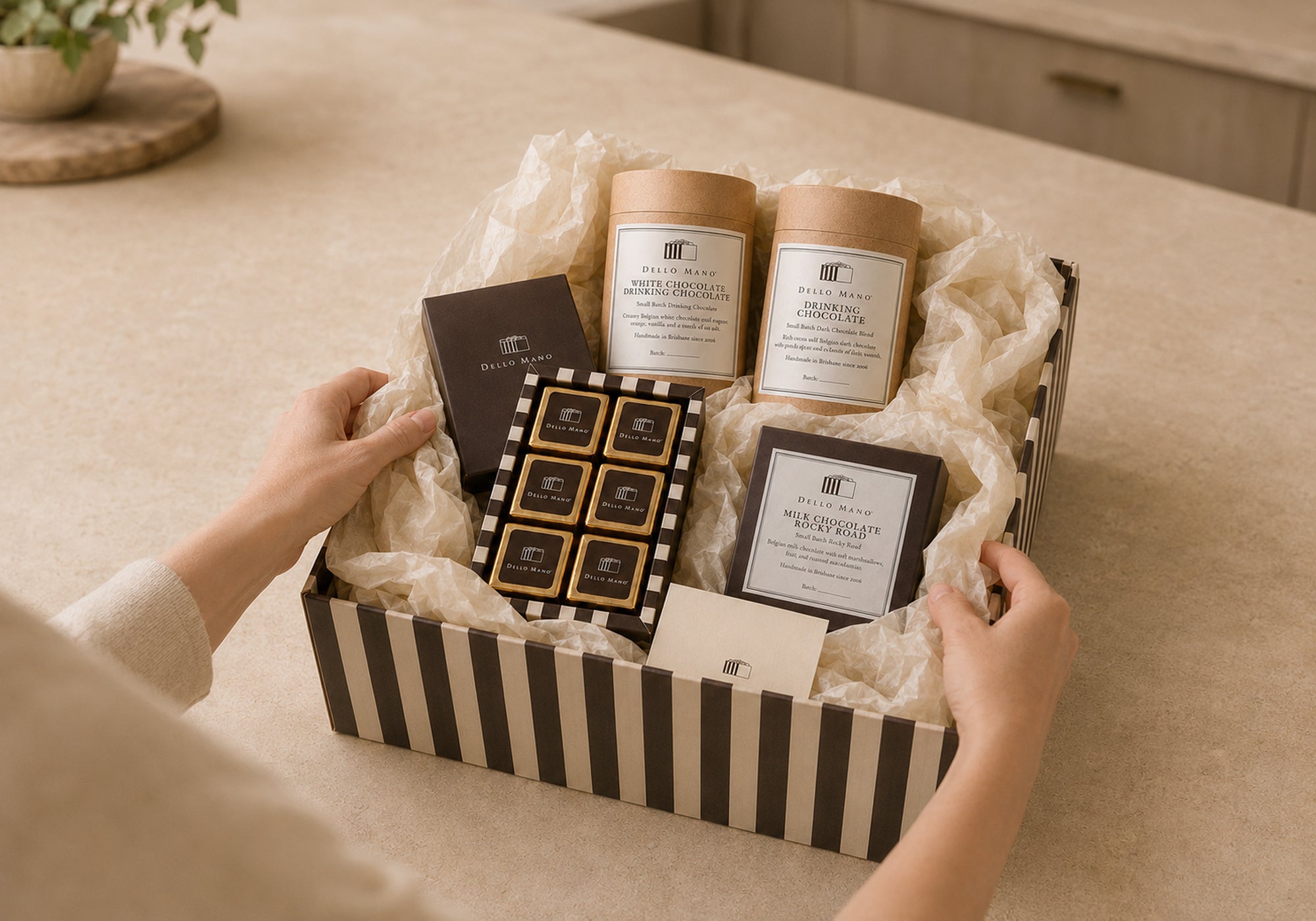 Dello Mano Chocolate Moments Hamper being packed by hand with Classic Luxury Brownies, two drinking chocolates, Rocky Road, cream tissue and a gift message.