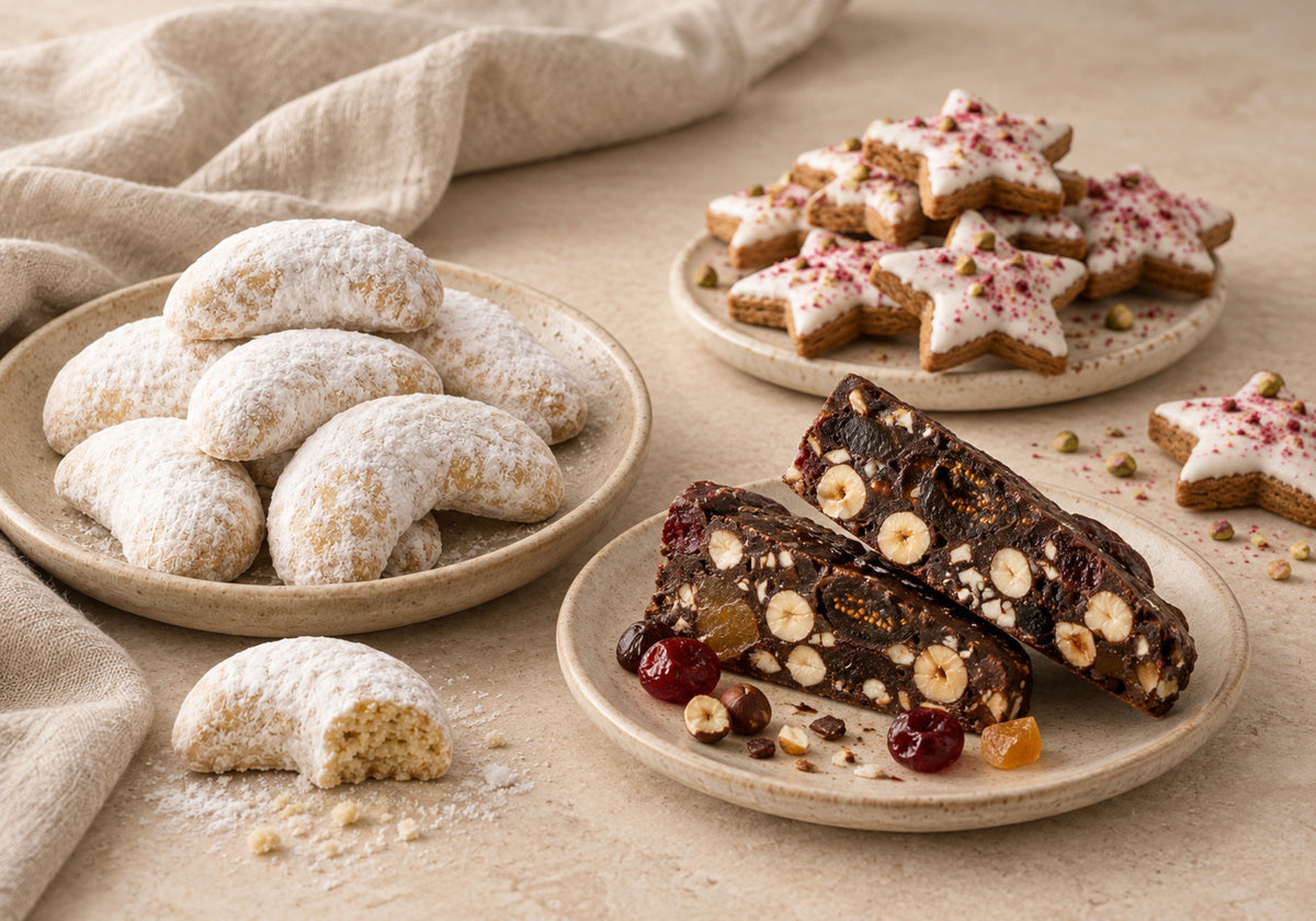 Dello Mano Panforte, Greek-style Kourabiedes and iced Christmas gingerbread arranged on a warm neutral table