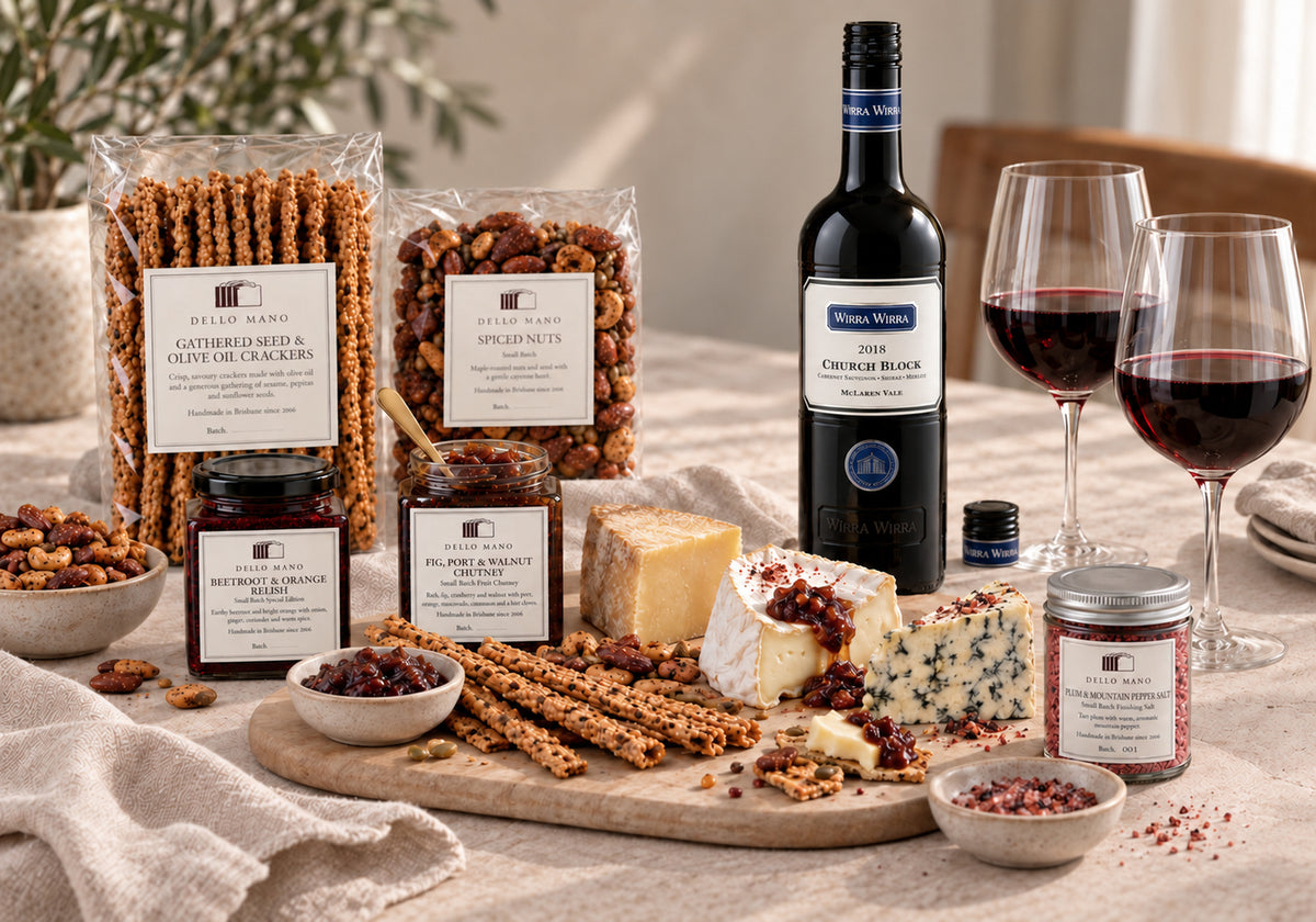 2018 Wirra Wirra Church Block wine with Dello Mano crackers, spiced nuts, beetroot relish, fig chutney and plum pepper salt beside a cheese board.