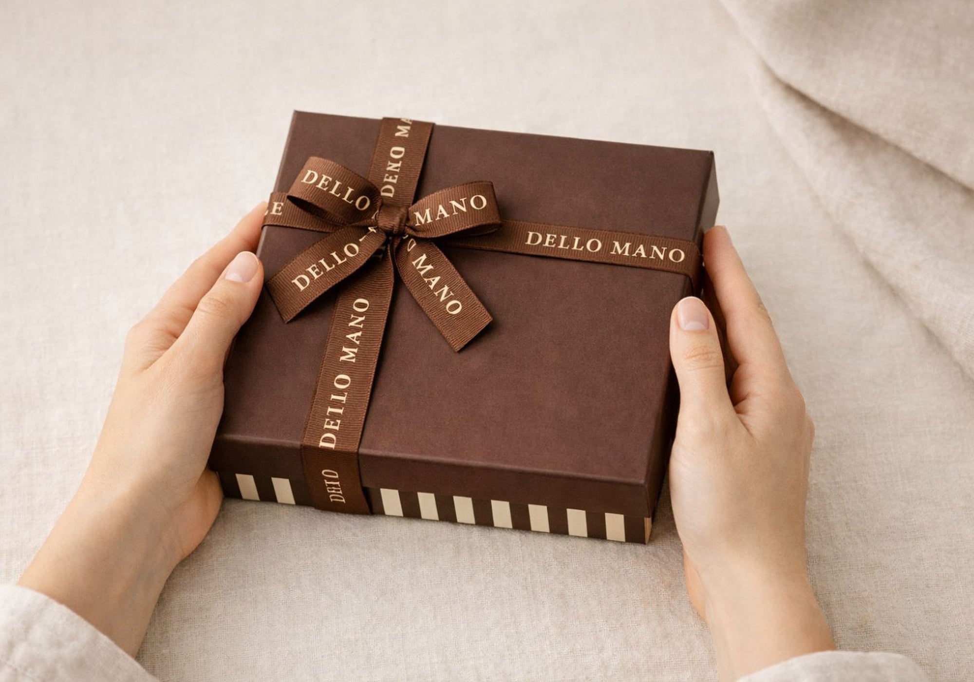 Handmade chocolate hamper gift box being prepared for delivery on soft linen background
