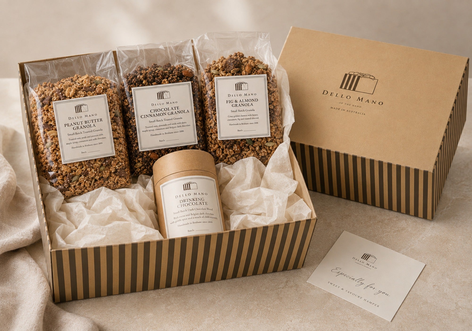 Gift-ready Dello Mano granola collection in an open striped hamper with Dark Drinking Chocolate, closed hamper and complimentary personal message.