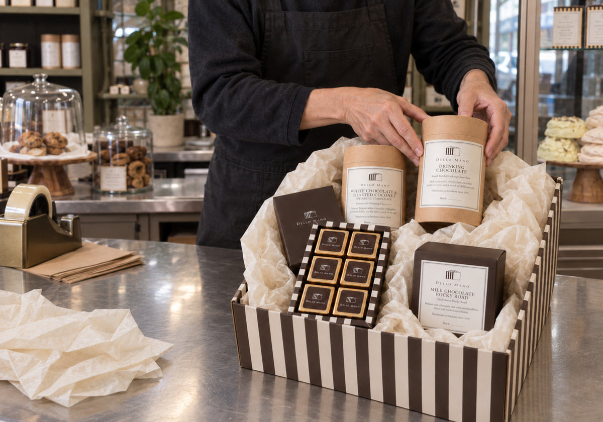 Dello Mano team member packing a handmade chocolate hamper at the West End Brisbane kitchen.