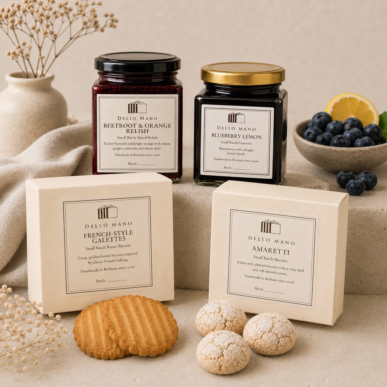 Dello Mano French-style galettes and amaretti biscuits with beetroot and orange relish and blueberry lemon conserve, styled on soft neutral linen.