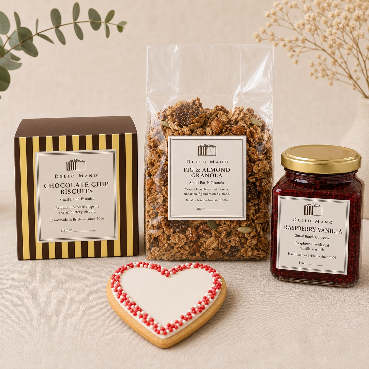 Dello Mano Little Luxuries selection with chocolate chip biscuits, fig and almond granola, raspberry vanilla conserve and a handmade heart gift cookie.