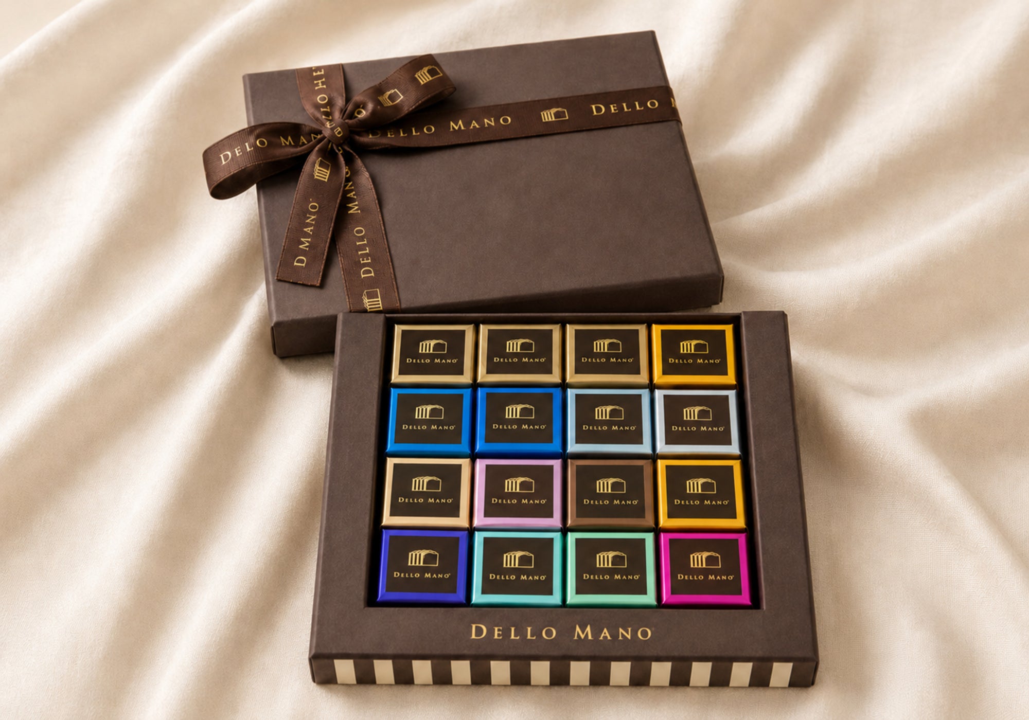 Open Dello Mano mixed Belgian chocolate brownie gift box with 16 individually wrapped brownies in colourful and gold foils.