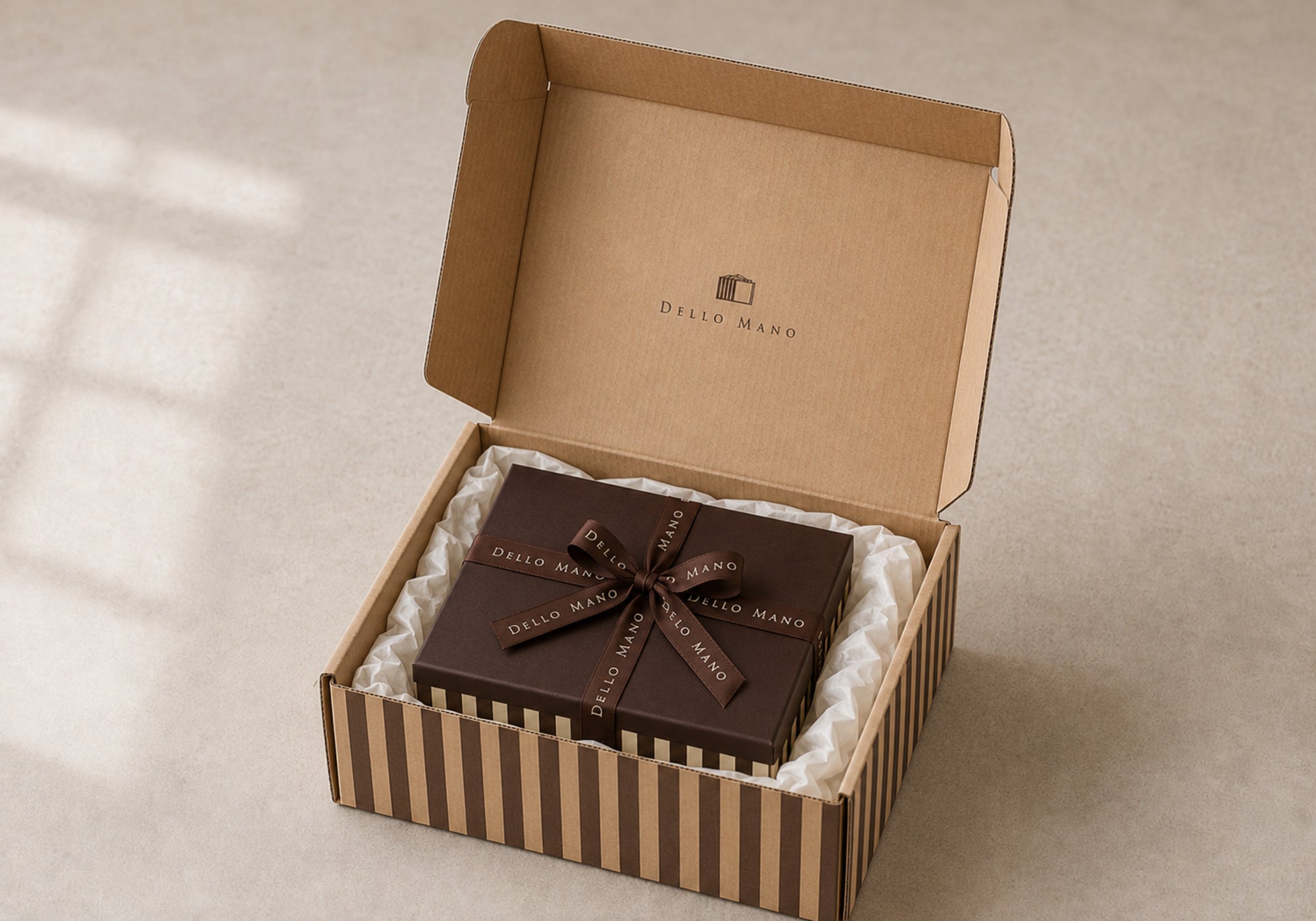 Square Dello Mano 16-piece brownie gift box packed with off-white tissue in a striped dispatch box for Australia-wide delivery