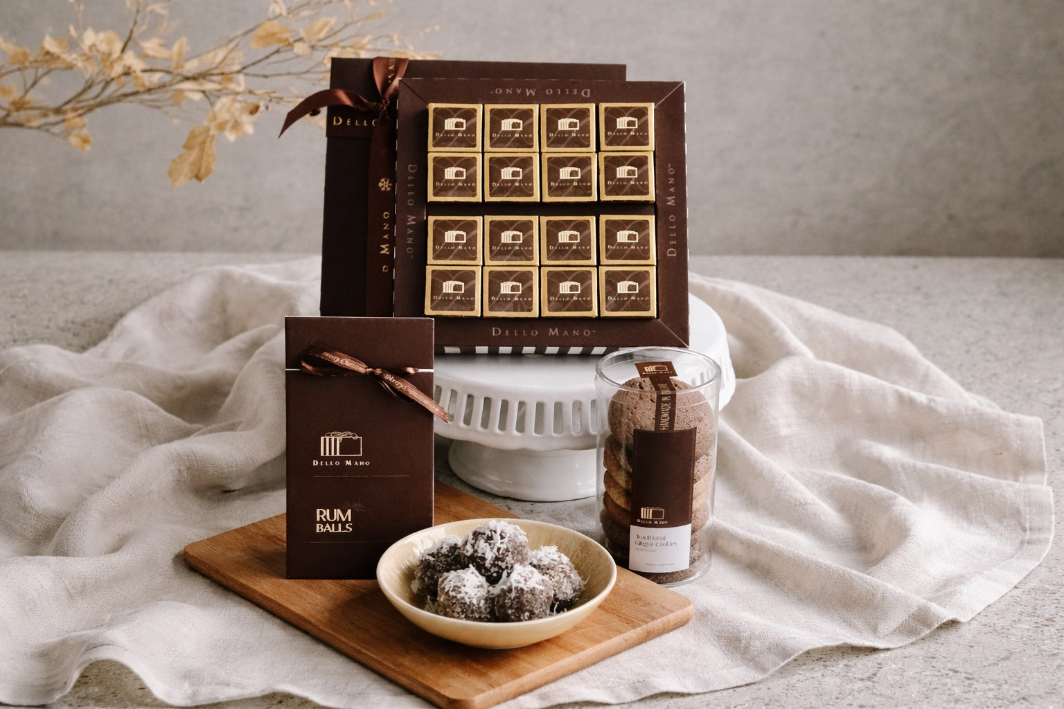 luxury gift hampers Australia with chocolate brownies cookies and handmade treats on linen background Dello Mano