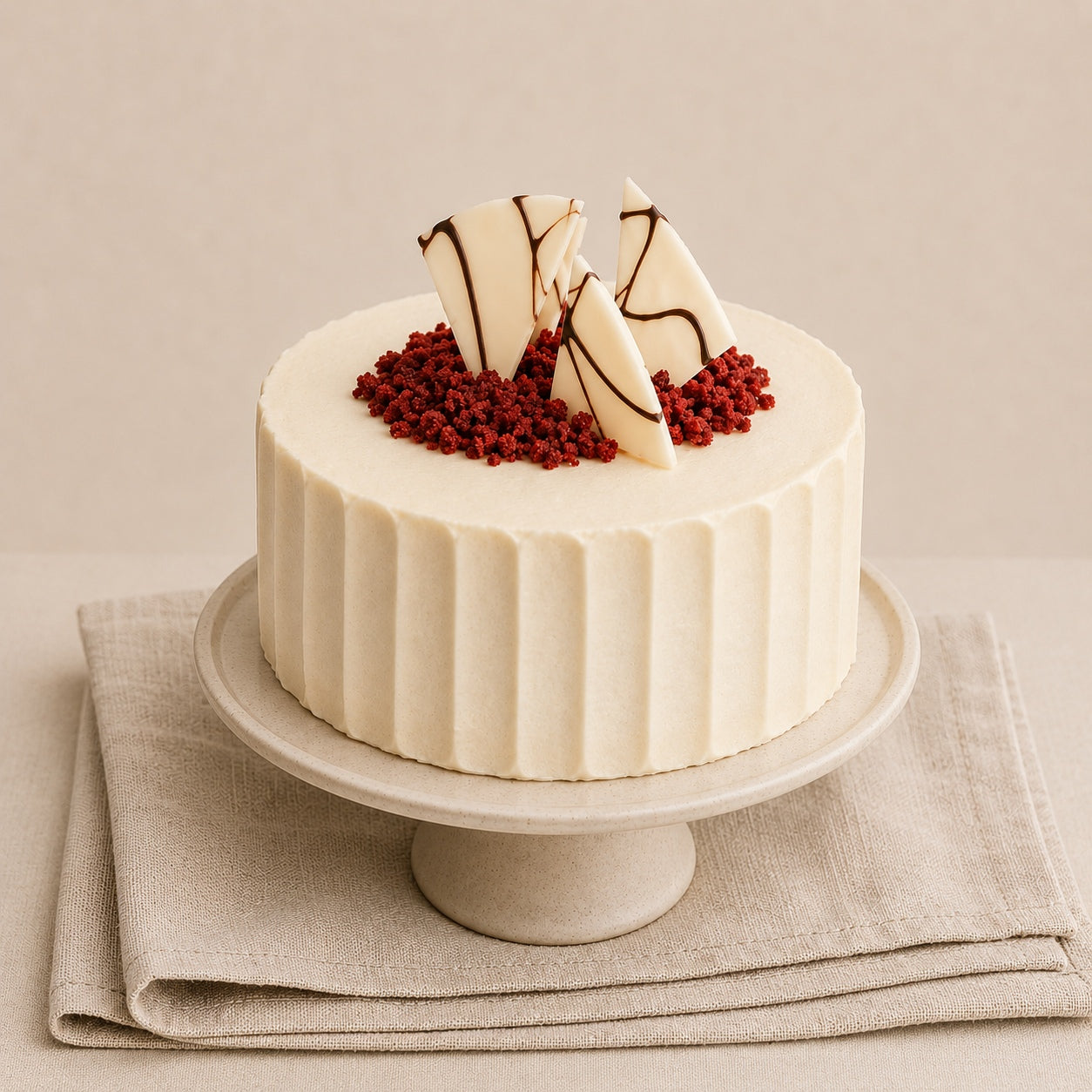 Handmade Red Velvet Cake with cream cheese frosting, red velvet crumb and white Belgian chocolate fan decoration on a linen background.