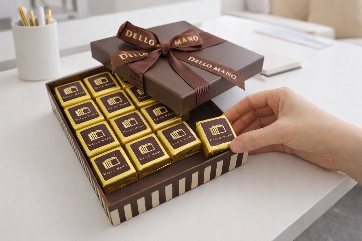 Handmade brownie gift box on a modern Brisbane office desk, beautifully wrapped and ready for delivery