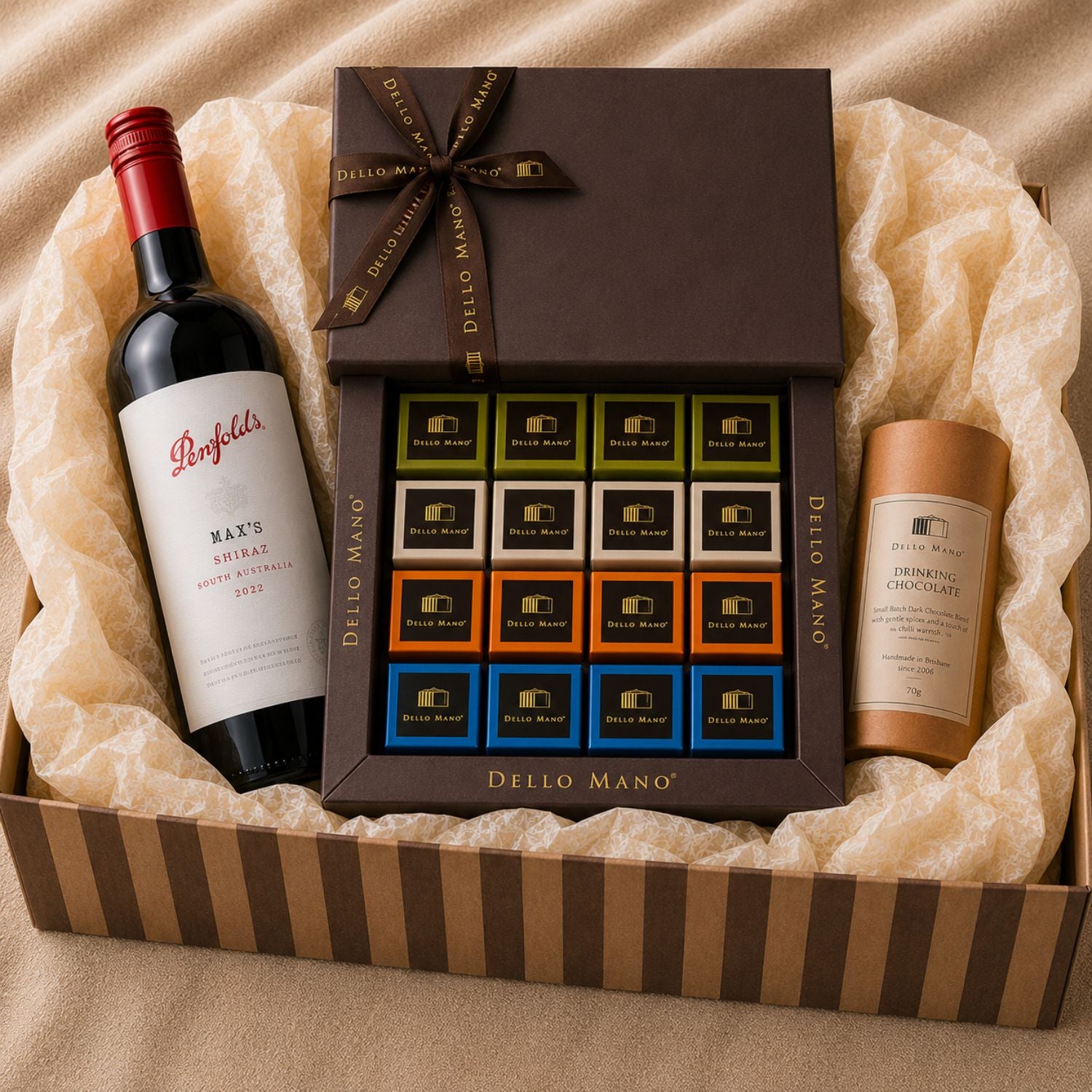 Dello Mano Chocolate Evening Hamper featuring Penfolds Max's Shiraz, Brownie Favourites Gift Box and Dark Drinking Chocolate in a striped gift hamper.