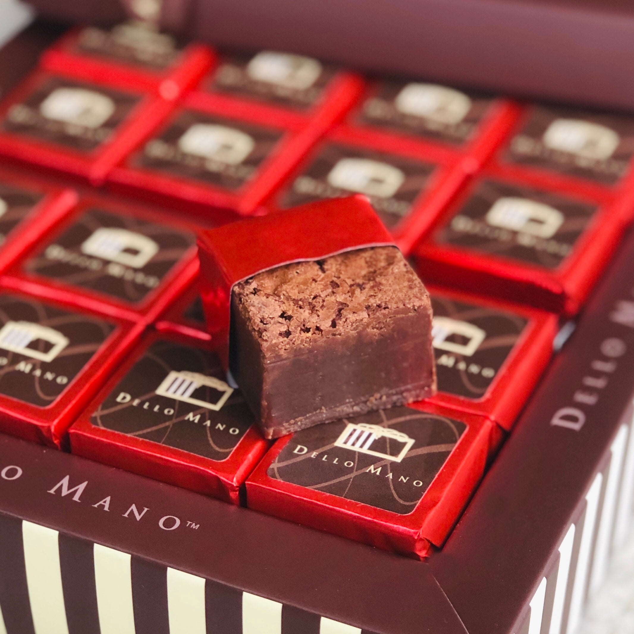 Open brownie gift box and on top an open foil gluten free brownie