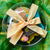 The top of an Easter cookie gift box finished with yellow and white checked ribbon