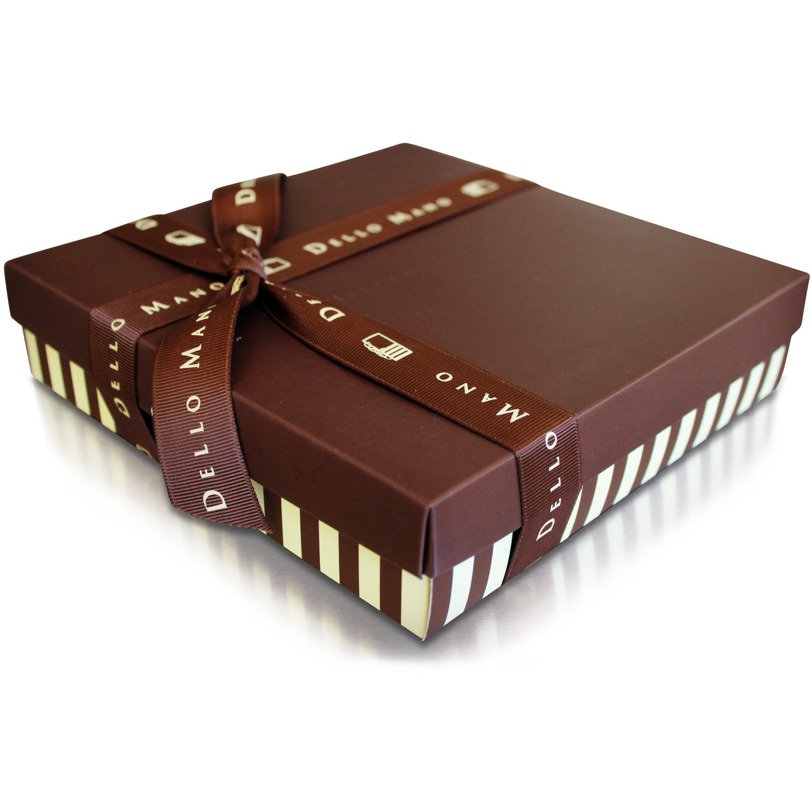 A colourful mixed box of brownies. Individually foil wrapped brownies in a box with labels that say Dello Mano. One brownie on top has foil open to show rich brownie inside.